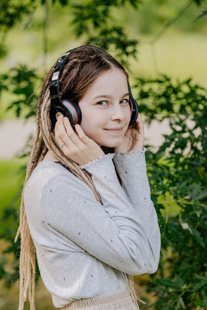 Woman in Gray Long Sleeve Shirt Wearing Black Headphones